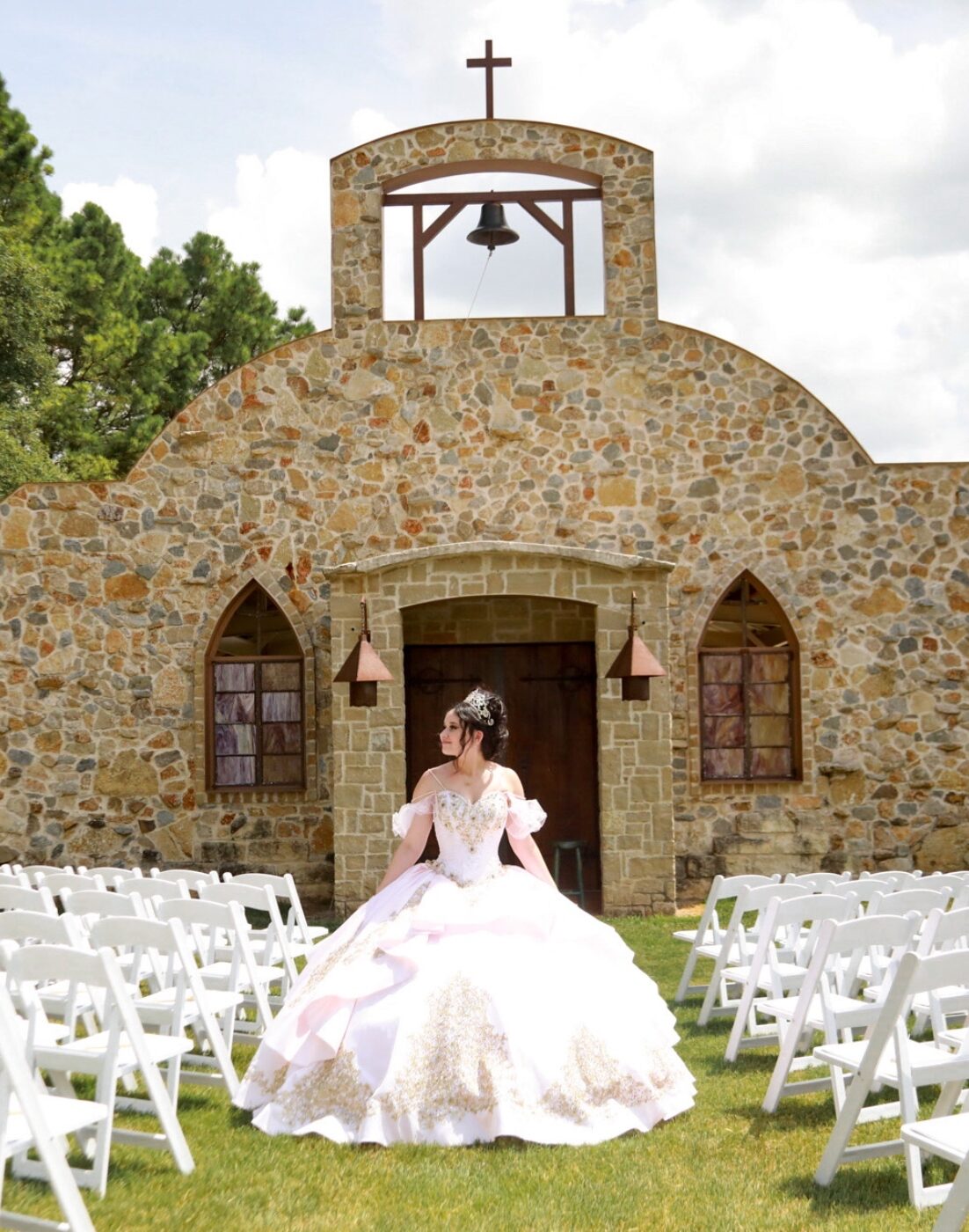 Hollow Hill Event Center Wedding and Event Venue, Weatherford, Texas. Girl standing between stairs setup in front of stone alamo style building
