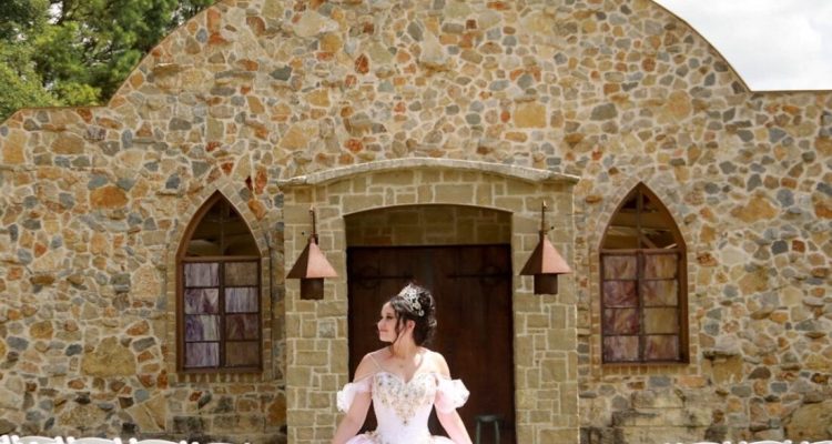 Hollow Hill Event Center Wedding and Event Venue, Weatherford, Texas. Girl standing between stairs setup in front of stone alamo style building