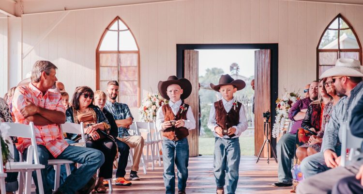 Hollow Hill Event Center Wedding and Event Venue, Weatherford, Texas. Ring bearers walking into ceremony